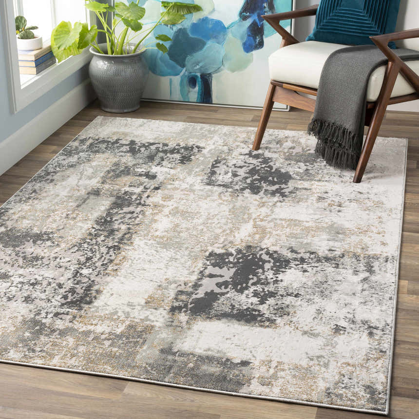 Living room scene with a Kiana Area Rug, contemporary style, in gray, white, and gold tones. Roomscene-Rectangle