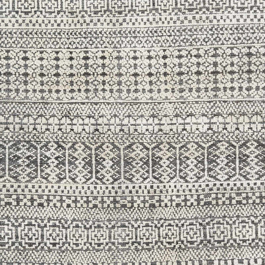 Close-up of the Kiara Area Rug showing the hand-knotted wool texture and geometric black and light gray pattern. Swatch