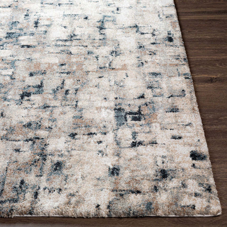 Close-up of the Kilbirnie Area Rug showing its cream, beige, teal, and black contemporary pattern and soft texture. Front
