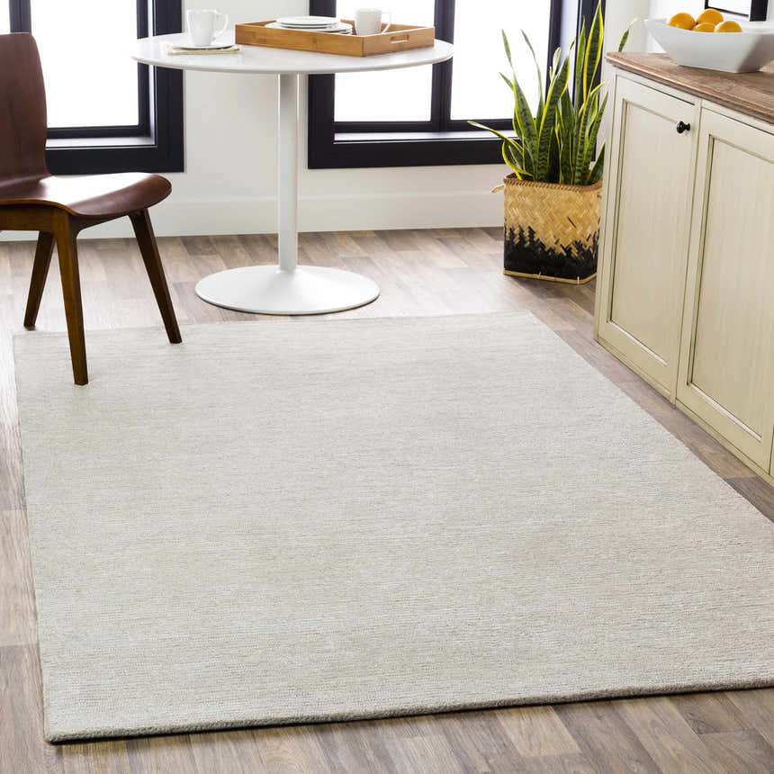 Light gray Keller Area Rug in a bright dining room with wood floors and modern white table. Roomscene-Rectangle