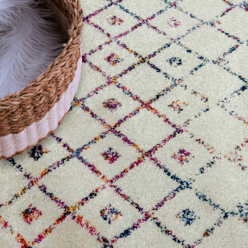 Close-up of the Marash KMRSH-4600 area rug featuring a colorful diamond pattern on an off-white background. Styleshot