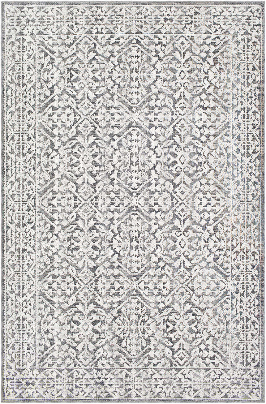 Close-up of the Kinglake Area Rug. Bohemian style rug in shades of gray and white with a geometric floral pattern. Design-Rectangle-5373