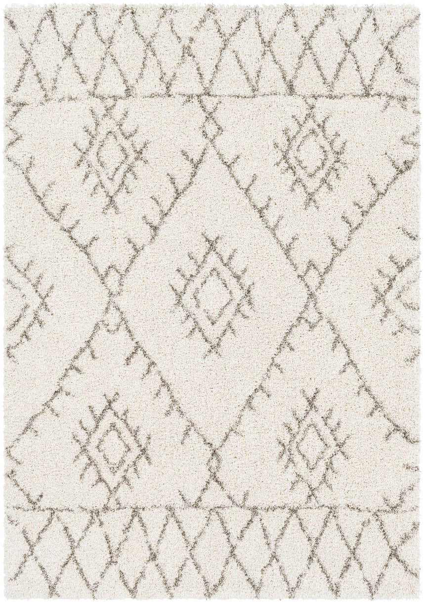 Close up of the Kunia Area Rug featuring a shag texture and a geometric diamond pattern in ivory and charcoal. Design-Rectangle-5373