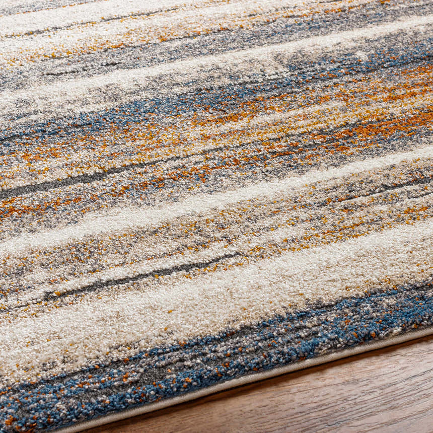 Close-up of the Kylo Area Rug showing its dark beige, brown, and off-white geometric pattern and soft, textured pile. Texture