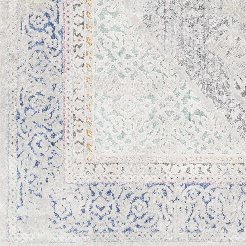 Close-up of the Laplace Area Rug showing its traditional, vintage pattern in blue, charcoal, sage, and light gray. Swatch