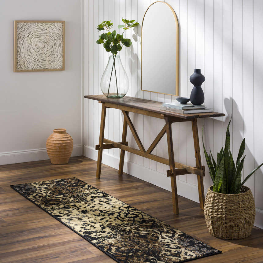 Entryway with wood floors and console table featuring the Lawtell Area Rug in black, beige, and brown. Roomscene-Runner