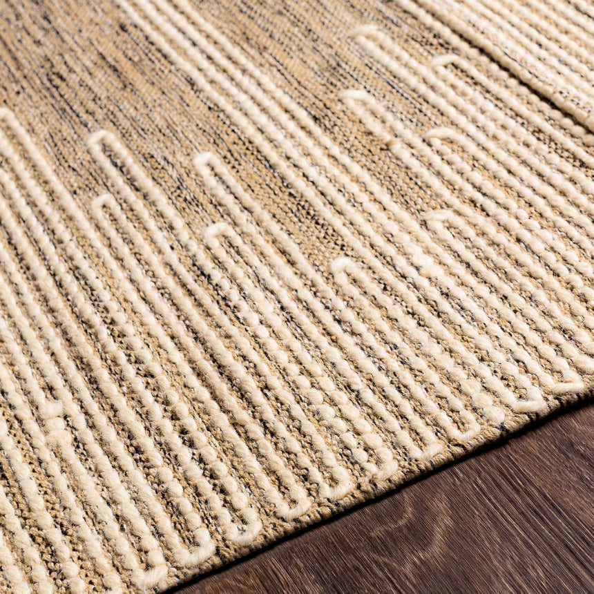 Close up of the Lucasville Area Rug showing its tan, cream, and black woven texture and geometric design. Texture