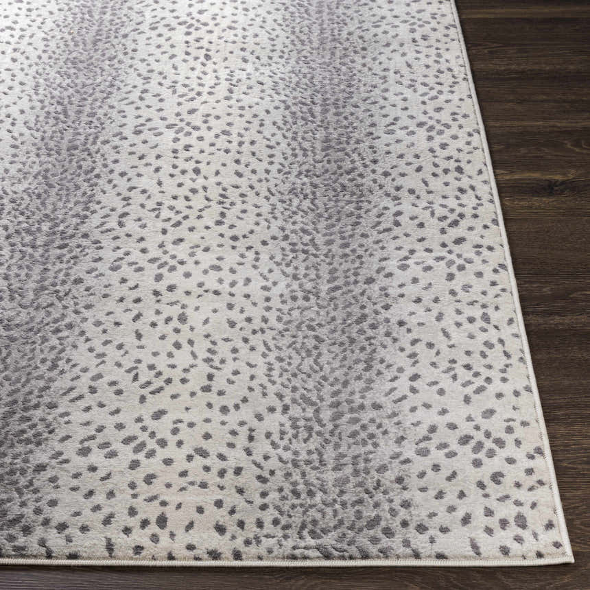 Close-up of Pointblank Gray Antelope Print Rug. Charcoal and gray spots on ivory background. Contemporary style. Front
