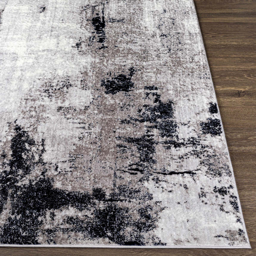 Close-up of the Limao Abstract Denim Area Rug showing its cream, gray, and black abstract pattern and soft texture. Front