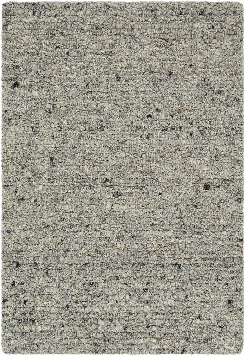 Close-up of the hand-tufted Winta Charcoal Wool Area Rug. Ash, gray, and sage tones create a textured, farmhouse style. Design-Rectangle-23