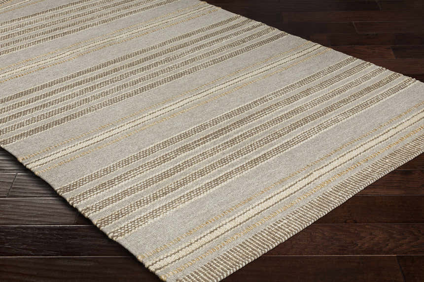 Close-up of the Allendorf Area Rug showing beige, charcoal, and cream stripes on a hand-woven wool texture. Corner