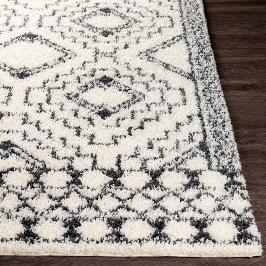 Close-up of the Lloydminster Area Rug, a black and cream shag rug with a Moroccan-inspired diamond pattern. Front
