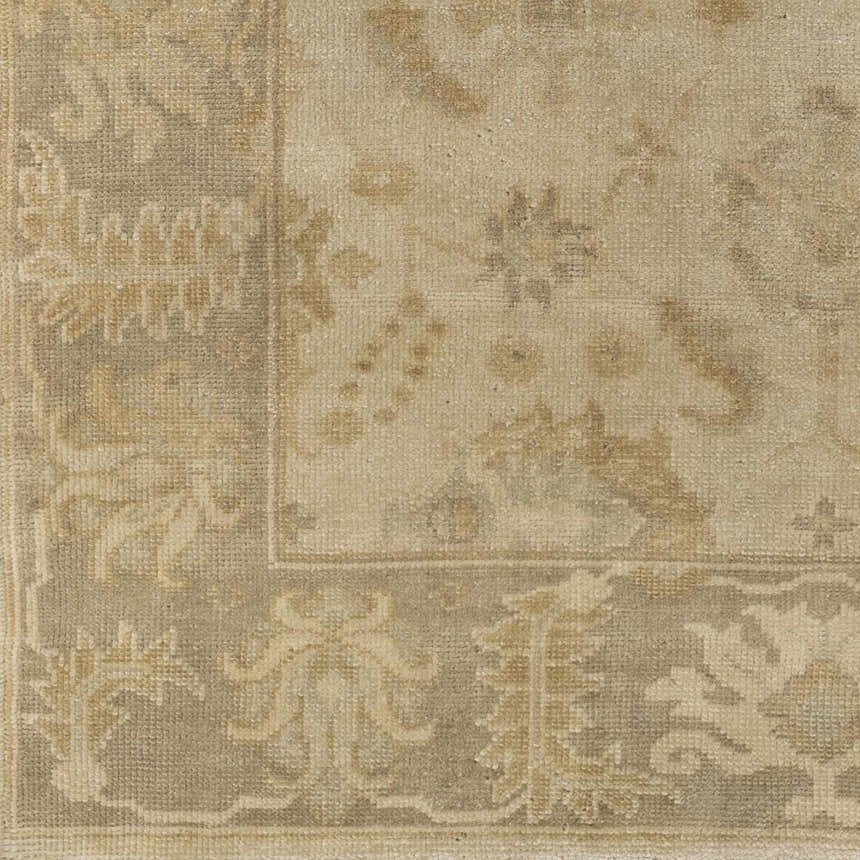 Close-up of the hand-knotted Longisland Clearance Rug. Features light beige and wheat tones with a traditional floral pattern. Swatch