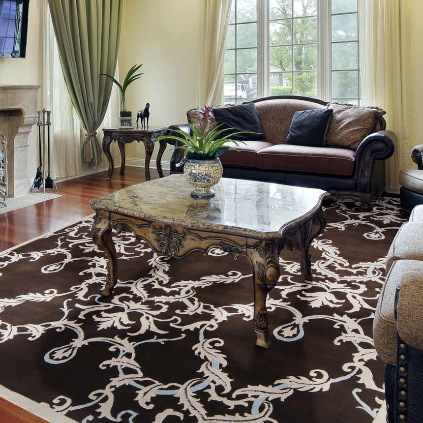 Living room scene with a brown Ludlam Area Carpet featuring a light floral pattern. Roomscene-Rectangle