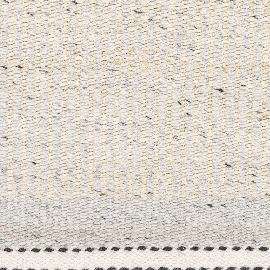 Close-up of the hand woven Lumatil Area Rug. Jute and wool rug with black, cream, and gray hues. Farmhouse style texture. Swatch