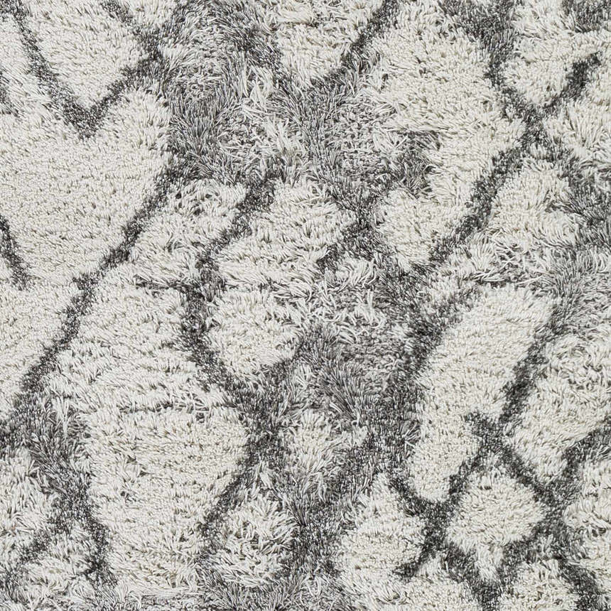 Close-up of the Lowesville Area Rug, a shag rug with a geometric gray and off-white pattern. Swatch