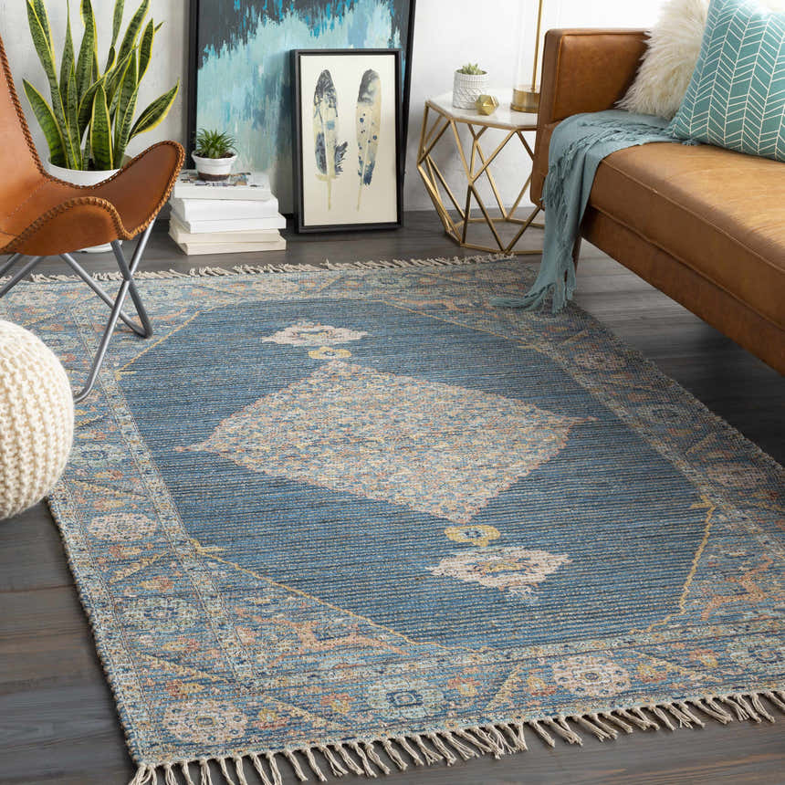 Bohemian living room with brown leather sofa and Macon Blue Medallion Jute Rug, a hand woven accent. Roomscene-Rectangle