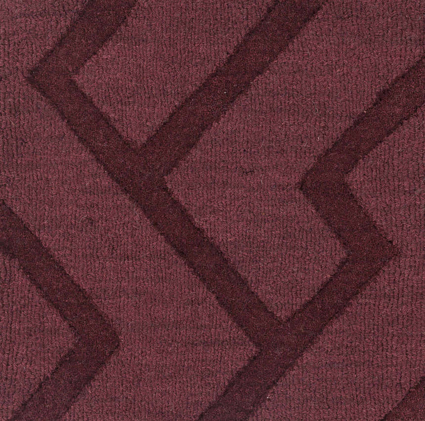 Close-up of the plum Magness Area Rug, a hand-loomed wool rug with a contemporary geometric pattern. Texture