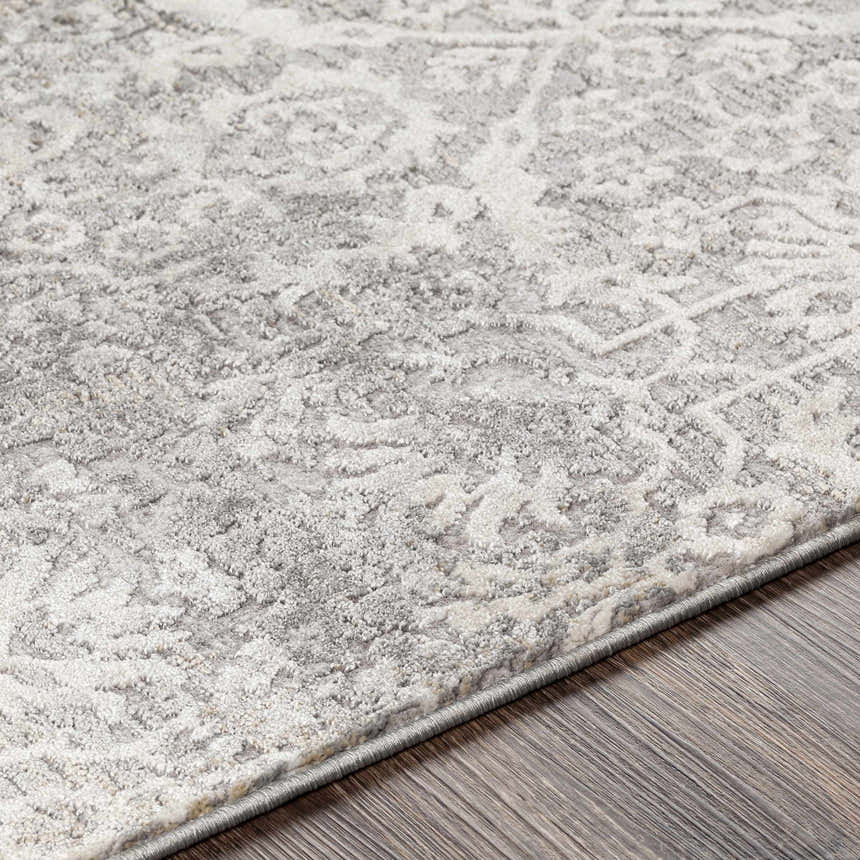 Close-up of the textured Mandurah Area Rug - Clearance. Cream and gray traditional pattern on a machine-woven rug. Texture