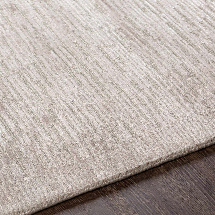 Close up of the hand knotted Mardi Area Rug in charcoal and light beige. Texture