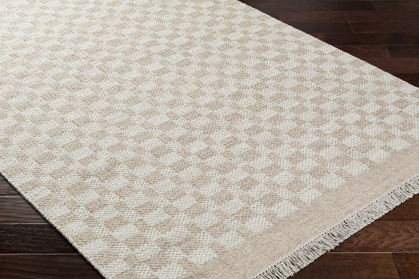 Close-up of the Meira Tan Area Rug showing its ivory and tan checkered, hand-woven design and wool texture. Corner