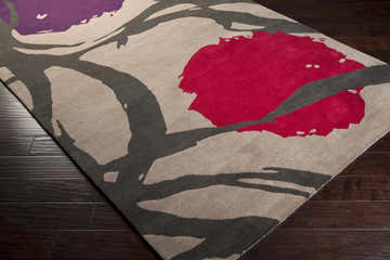 Close-up of the hand-tufted Mcwhorter Area Rug. Features a contemporary floral design in red, purple, gray, and beige. Corner