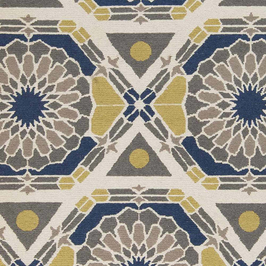 Close-up of the Mesena Area Rug. Ivory wool rug with a geometric pattern in navy, light gray, and tan. Hand-knotted texture. Swatch