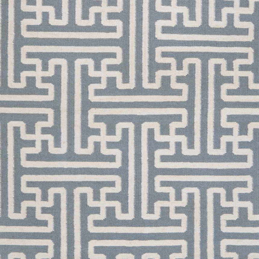 Close-up of the Metuchen Area Rug. Light blue wool rug with a geometric, light beige maze-like pattern. Swatch