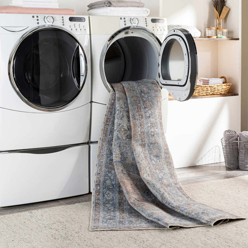 Mianay Washable Area Rug in laundry room being washed. Blue, beige oriental rug in dryer. Easy clean rugs. Washing-Machine