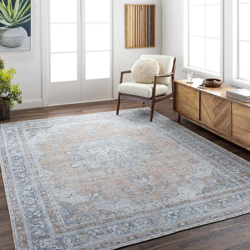Living room scene with a beige and blue Mianay Washable Area Rug, wood floors, white walls, and mid-century modern furniture. Roomscene-Rectangle
