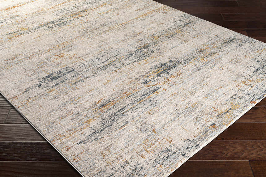 Close-up of the Midhurst Luxe Rug. Contemporary design in cream, gray, teal, and mustard colors. Abstract pattern. Corner