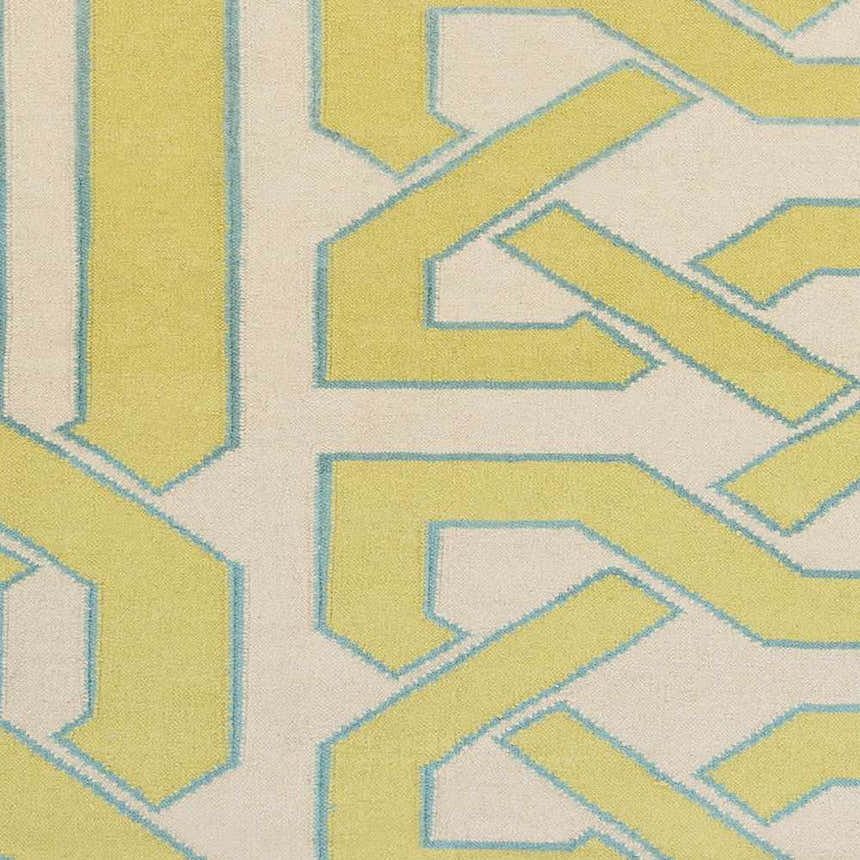 Close-up of the Milano Area Rug. Hand-woven wool rug in ivory, light olive, and seafoam with a geometric pattern. Swatch