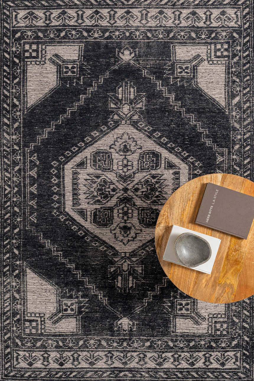 Close-up of the Minapan Premium Area Rug in black and cream, showcasing its traditional, hand-knotted design and geometric patterns. Styleshot