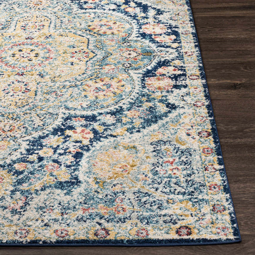 Close-up of the Mallacoota Area Rug showing its cream, navy, yellow, and pink traditional oriental pattern. Front