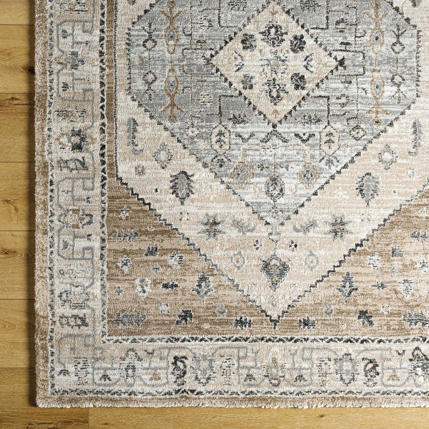 Close-up of the Minal Luxe Thick Area Rug. Farmhouse style rug with a traditional gray and beige diamond pattern. Corner
