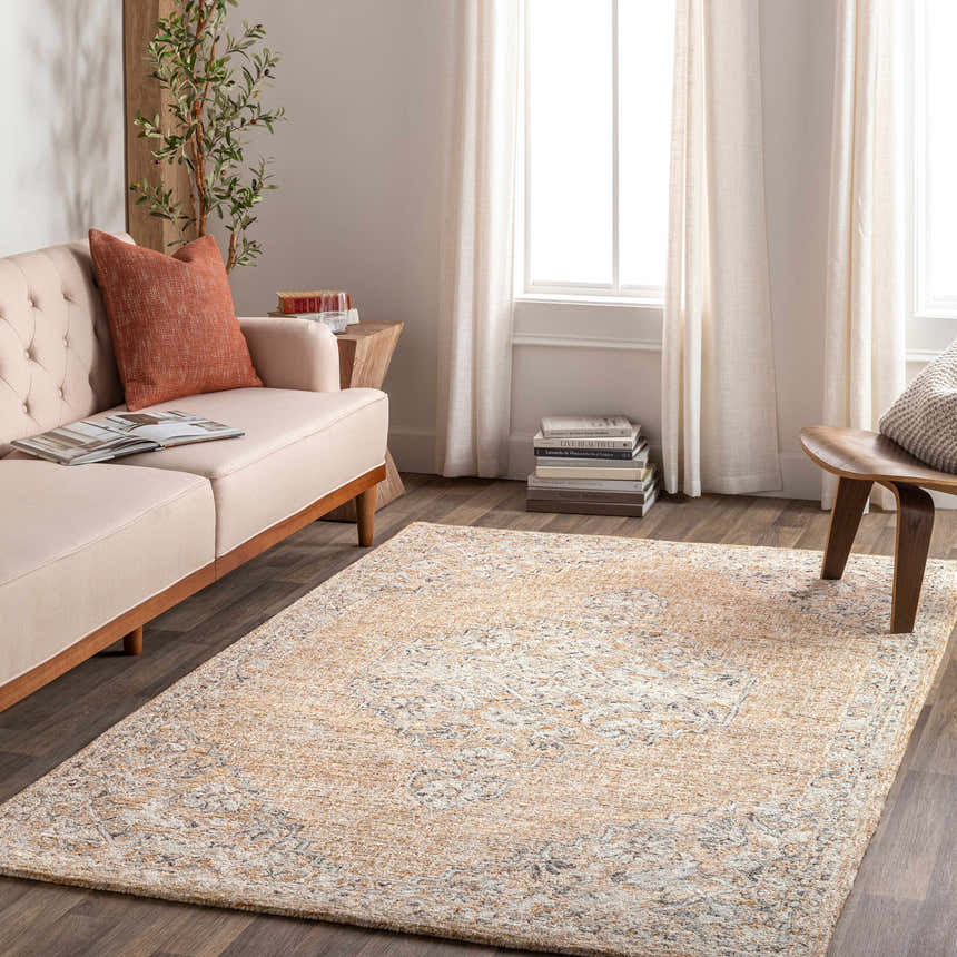 Living room scene with a tan sofa and the Modimolle Area Carpet in brown, camel, and cream tones. Roomscene-Rectangle