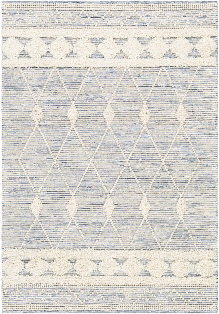 Close-up of the hand woven Moe Area Rug. Features a blue and cream diamond pattern with textured details. Design-Rectangle-576