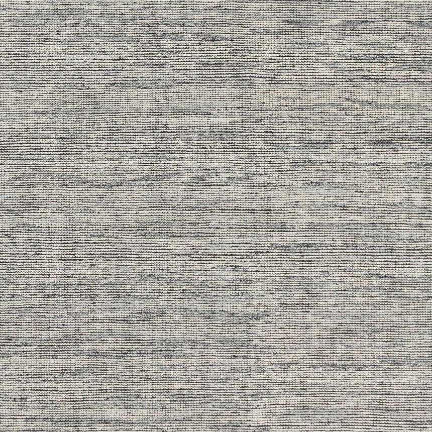 Close-up of the hand-knotted Molena Area Rug. Denim, ink blue, light olive, and light sage wool create a contemporary striped texture. Texture