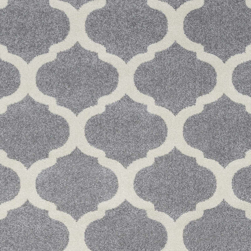 Close-up of the Mongo Carpet featuring a slate gray backdrop and a cream-colored quatrefoil pattern. Swatch