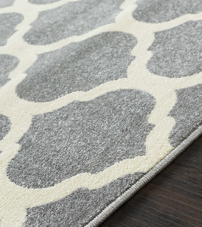 Close-up of the Mongo Carpet in cream and slate, featuring a contemporary geometric pattern and machine-woven texture. Texture