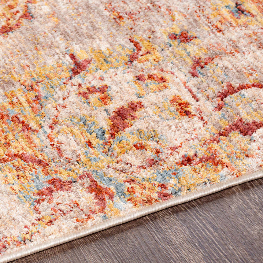 Close-up of the Morinville Area Rug. Features brick red, charcoal, light beige, and mustard colors in a traditional pattern. Texture
