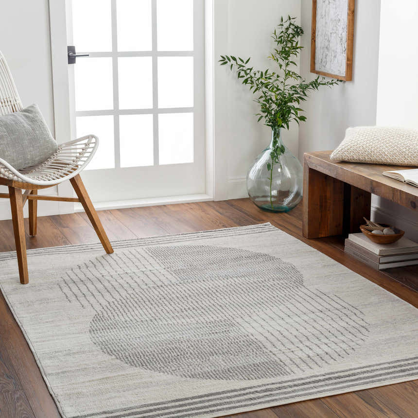 Entryway with Amar Area Rug in gray geometric pattern, white chair, and wooden bench. Roomscene-Rectangle