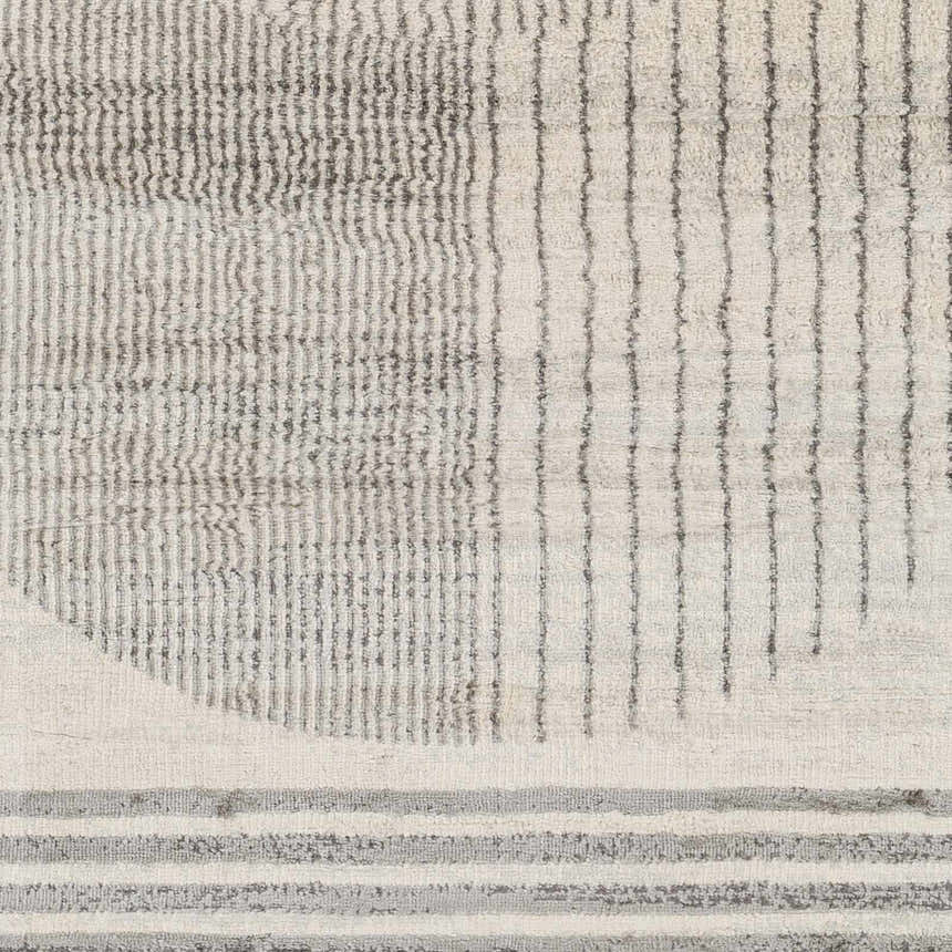 Close-up of the Amar Area Rug, showcasing its geometric pattern in dark gray, gray, and natural gray. Swatch