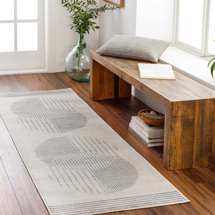 Entryway scene with a gray and natural gray Amar Area Rug runner and wooden bench. Roomscene-Runner