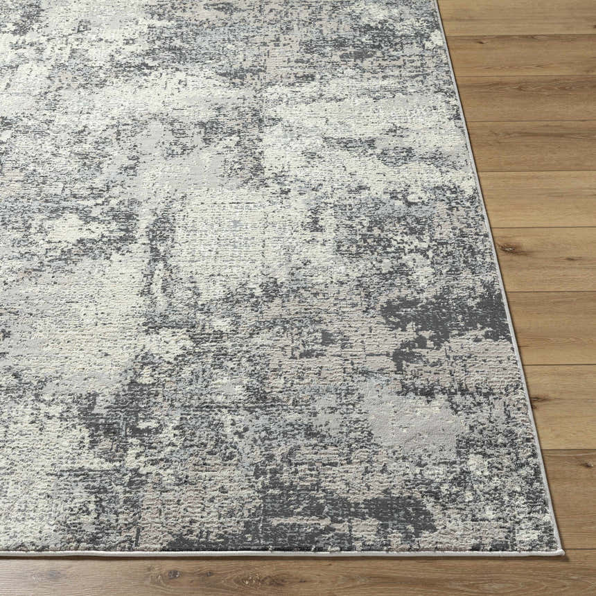 Close-up of the Marci Area Rug showing its charcoal, cream, and gray abstract Southwestern design and recycled PET yarn texture. Front