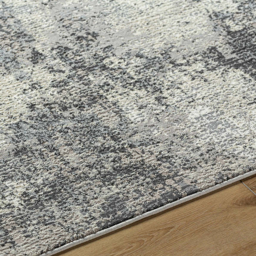 Close-up of the Marci Area Rug showing its charcoal, cream, and gray Southwestern design and recycled PET yarn texture. Texture