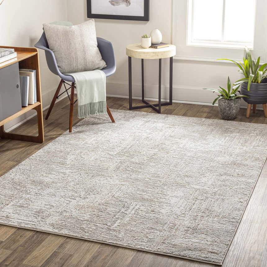 Living room scene with a bone and sage Nannyville Area Rug, chair, side table, and plants. Roomscene-Rectangle