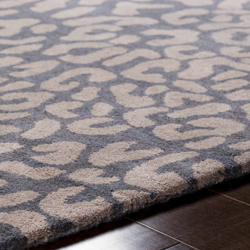 Close up of the gray Neoma Animal Print Wool Rug showing its hand-tufted texture and contemporary design. Texture