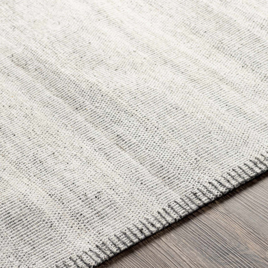 Close-up of the hand-woven Nettleham Silver Viscose Rug, showing charcoal and silver gray tones and textured cotton and viscose blend. Texture