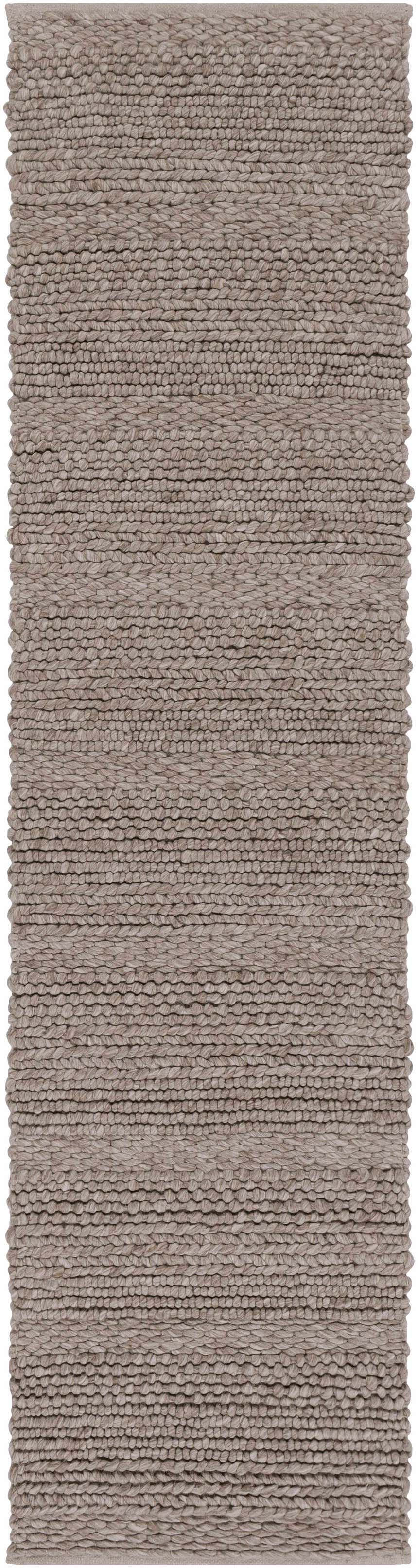 Close-up of the hand woven Newfolden Area Carpet. Brown, charcoal, and ivory wool rug with a textured, natural fiber look. Design-Runner-2610
